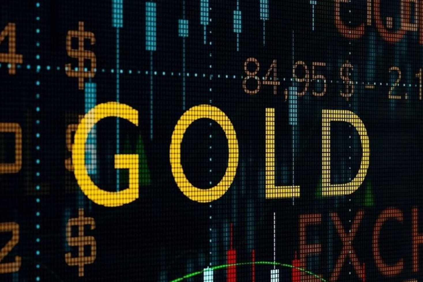 The word Gold in capital letters and coloured in gold metallic with a green arrow pointing upwards, numbers, and the word exchange in the background with a chart.